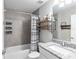 Bathroom features a shower with black and white striped curtain, granite countertop, and wood shelves at 18301 Sw 69Th Loop, Dunnellon, FL 34432