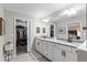 Bathroom with double vanity, granite counters, and views into the walk-in closet at 18301 Sw 69Th Loop, Dunnellon, FL 34432