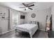 This cozy bedroom features a dark ceiling fan and gray wood-look floors at 18301 Sw 69Th Loop, Dunnellon, FL 34432