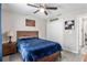 The bedroom has a ceiling fan, a window, gray wood-look floors, and sports-themed decor at 18301 Sw 69Th Loop, Dunnellon, FL 34432