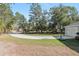 Wide curved driveway leading up to the side entry garage and basketball court at 18301 Sw 69Th Loop, Dunnellon, FL 34432