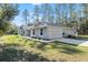 Side view of a well-maintained home featuring a two-car garage and manicured landscaping at 18301 Sw 69Th Loop, Dunnellon, FL 34432