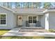 Charming front porch with rocking chairs and a welcoming wreath on the front door at 18301 Sw 69Th Loop, Dunnellon, FL 34432