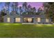 Charming one-story home with manicured lawn, inviting entry and a row of pines in the background at 18301 Sw 69Th Loop, Dunnellon, FL 34432