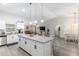 Bright kitchen featuring white cabinetry, granite countertops, breakfast bar, and open layout at 18301 Sw 69Th Loop, Dunnellon, FL 34432