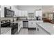 Well-appointed kitchen featuring granite countertops, stainless steel appliances, and white cabinetry at 18301 Sw 69Th Loop, Dunnellon, FL 34432