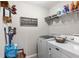 Bright laundry room with modern appliances, shelving and cute decor at 18301 Sw 69Th Loop, Dunnellon, FL 34432