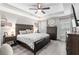 Tranquil main bedroom with wood-look flooring, neutral walls, and a ceiling fan at 18301 Sw 69Th Loop, Dunnellon, FL 34432