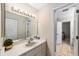 Bright bathroom featuring a large mirror with Hollywood lights and a sink vanity at 1947 Se 37Th Court Cir, Ocala, FL 34471