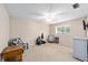 Carpeted bedroom with a ceiling fan, window, and two chairs at 1947 Se 37Th Court Cir, Ocala, FL 34471