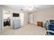 Spacious bedroom featuring a ceiling fan, neutral carpet, and doorways to a closet and ensuite bathroom at 1947 Se 37Th Court Cir, Ocala, FL 34471