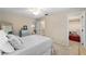 Bright bedroom featuring a ceiling fan, neutral carpet, and doorways to an ensuite bathroom and walk-in closet at 1947 Se 37Th Court Cir, Ocala, FL 34471