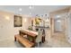 Inviting dining room featuring a wooden table with bench seating, stylish decor, and easy access to the kitchen at 1947 Se 37Th Court Cir, Ocala, FL 34471