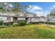 Well-kept townhouse with lush lawn, decorative landscaping, attached garage, and welcoming curb appeal at 1947 Se 37Th Court Cir, Ocala, FL 34471