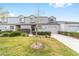 Inviting townhome showcasing an attached garage, landscaped front yard and traditional facade with updated colors at 1947 Se 37Th Court Cir, Ocala, FL 34471