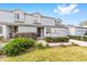 Welcoming two-story townhome featuring a landscaped front yard, traditional facade, and attached garage at 1947 Se 37Th Court Cir, Ocala, FL 34471