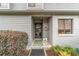 Inviting front door with a decorative wreath, well-maintained bushes, and tidy landscaping at 1947 Se 37Th Court Cir, Ocala, FL 34471