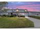 Charming townhome with a well-manicured lawn and a lovely pink and blue sunset backdrop at 1947 Se 37Th Court Cir, Ocala, FL 34471