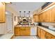 Charming kitchen featuring wooden cabinets, neutral countertops, and an open view into the living area at 1947 Se 37Th Court Cir, Ocala, FL 34471