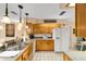 Bright kitchen featuring oak cabinets, white appliances, and view to breakfast table at 1947 Se 37Th Court Cir, Ocala, FL 34471