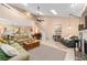 Airy living room with high ceilings, ceiling fan, staircase, fireplace and seamless flow into kitchen at 1947 Se 37Th Court Cir, Ocala, FL 34471