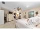 Inviting main bedroom with tile floors, a ceiling fan, and ample closet space, bathed in natural light at 1947 Se 37Th Court Cir, Ocala, FL 34471