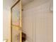 Tiled shower with glass door and bench; bright, tiled walls, and chrome fixtures at 1947 Se 37Th Court Cir, Ocala, FL 34471