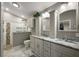 Modern bathroom with double sinks, granite countertops, and tiled walk-in shower at 1986 Altamonte Way, The Villages, FL 32162