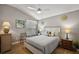 Cozy bedroom featuring a ceiling fan, a decorative headboard, and two bedside tables at 1986 Altamonte Way, The Villages, FL 32162