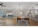 Bright dining area featuring a modern chandelier and seamless transition to the kitchen at 1986 Altamonte Way, The Villages, FL 32162