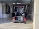 A golf cart is in the garage, with an automatic garage door on the left at 1986 Altamonte Way, The Villages, FL 32162