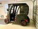 A golf cart is in the garage, with an automatic garage door on the right at 1986 Altamonte Way, The Villages, FL 32162
