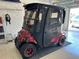 Enclosed golf cart parked inside of a garage with black mats on the floor at 1986 Altamonte Way, The Villages, FL 32162