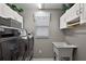 Bright laundry room with modern appliances, ample storage, and a utility sink at 1986 Altamonte Way, The Villages, FL 32162