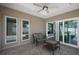 Covered patio with a seating area, ceiling fan, and views of the backyard at 1986 Altamonte Way, The Villages, FL 32162