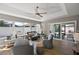 Bright sun room with ceiling fan, neutral colors, and sliding glass doors to the outside at 1986 Altamonte Way, The Villages, FL 32162