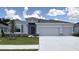 Charming single-story home featuring a two car garage, neutral paint, stone accents and a well manicured lawn at 3071 Canopy Oak Blvd, Wildwood, FL 34785