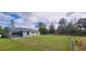 A full view of the home's fenced backyard featuring a well-maintained lawn and storage shed at 3326 Sw 128Th Street Rd, Ocala, FL 34473