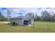 View of the home's fenced backyard featuring a storage shed and well-maintained lawn at 3326 Sw 128Th Street Rd, Ocala, FL 34473