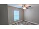 Bedroom features a ceiling fan, a window with blinds, and wood-look vinyl flooring at 3326 Sw 128Th Street Rd, Ocala, FL 34473