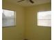 Bedroom featuring a ceiling fan and two windows at 3900 Sw 147Th Lane Rd, Ocala, FL 34473