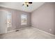 Neutral bedroom with carpet, a ceiling fan, natural light, and a closet offering a comfortable living space at 4491 Sw 49Th Ave, Ocala, FL 34474