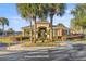 Community clubhouse featuring manicured landscaping, decorative palm trees, and nearby playground at 4491 Sw 49Th Ave, Ocala, FL 34474