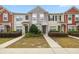 Townhomes featuring colorful exterior, well-maintained landscaping, and cozy front entryways at 4491 Sw 49Th Ave, Ocala, FL 34474