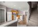 Kitchen with white appliances, wood cabinets, and an adjacent staircase at 4491 Sw 49Th Ave, Ocala, FL 34474