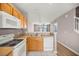 Kitchen featuring white appliances, wood cabinets, and tiled flooring at 4491 Sw 49Th Ave, Ocala, FL 34474