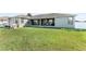 View of the back exterior and a lush yard at 4731 Se 32Nd St, Ocala, FL 34480