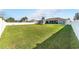 Expansive backyard with lush lawn and white vinyl fence at 4731 Se 32Nd St, Ocala, FL 34480