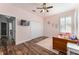 Bedroom featuring hardwood flooring, large closet, ceiling fan, and television at 4731 Se 32Nd St, Ocala, FL 34480