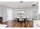 Dining room with modern table set and a view to the outside through shuttered windows at 4731 Se 32Nd St, Ocala, FL 34480